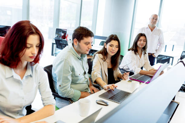 istock Dynamic Business Collaboration: Multiracial Business Team Engaged in a Productive Staff Meeting. Diverse Group  Planning Strategically, Brainstorming, Collaborating, and Working a Modern Office Setting 1913227414