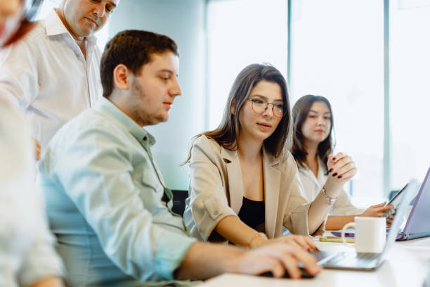 istock Dynamic Business Collaboration: Multiracial Business Team Engaged in a Productive Staff Meeting. Diverse Group  Planning Strategically, Brainstorming, Collaborating, and Working a Modern Office Setting 1913227416