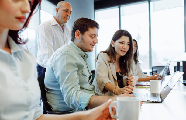 istock Dynamic Business Collaboration: Multiracial Business Team Engaged in a Productive Staff Meeting. Diverse Group  Planning Strategically, Brainstorming, Collaborating, and Working a Modern Office Setting 1913227928
