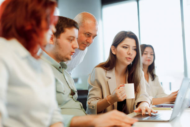 istock Dynamic Business Collaboration: Multiracial Business Team Engaged in a Productive Staff Meeting. Diverse Group  Planning Strategically, Brainstorming, Collaborating, and Working a Modern Office Setting 1913227939