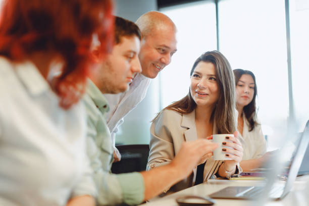 istock Dynamic Business Collaboration: Multiracial Business Team Engaged in a Productive Staff Meeting. Diverse Group  Planning Strategically, Brainstorming, Collaborating, and Working a Modern Office Setting 1913227940