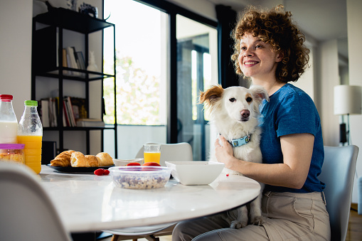 Woman has breakfast at home and enjoys it