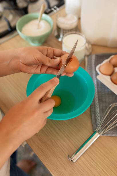 istock the process of breaking hen's eggs into a bowl, cracked shells 1913242385