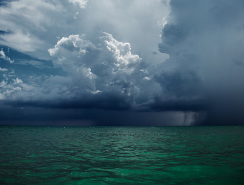 Powerful dramatic storm cell over ocean beach with golden light, Australia