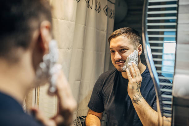 istock A young handsome man puts shaving cream on his face 1913297040
