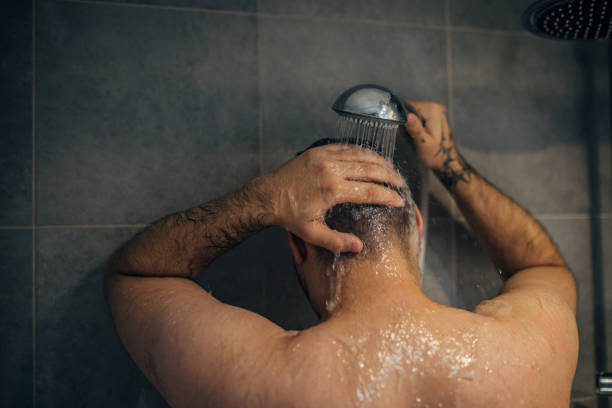 istock Handsome man washing hair 1913326215