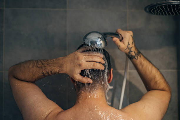istock Handsome man washing hair 1913327233