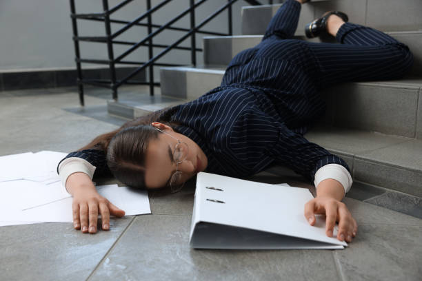 istock Unconscious woman with scattered folder and papers lying on floor after falling down stairs indoors 1913334348
