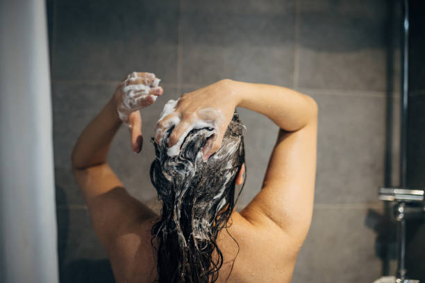istock A young woman washes her hair 1913334902