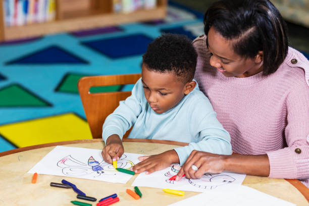 istock African-American boy, mother coloring together 1913334914