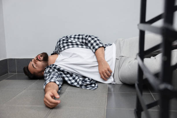 istock Unconscious man lying on floor after falling down stairs indoors 1913338884