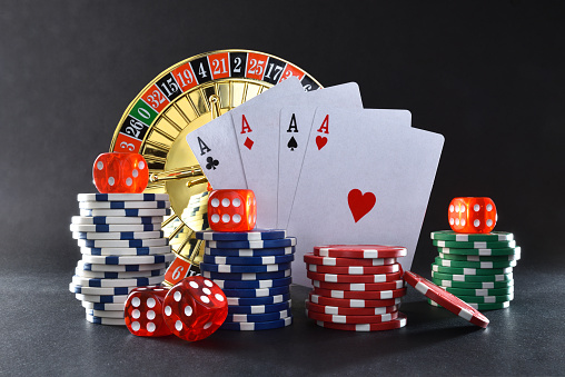 Dice and poker cards on white background