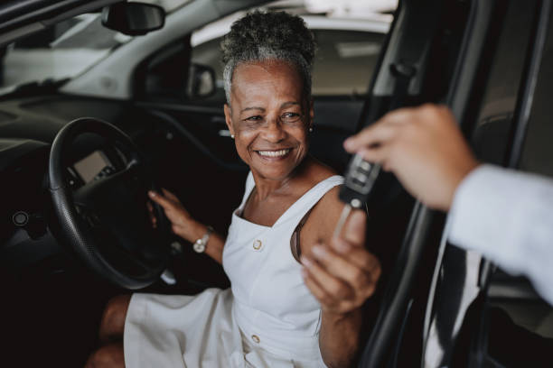 senior woman buying car - car old african descent car salesperson stock-fotos und bilder