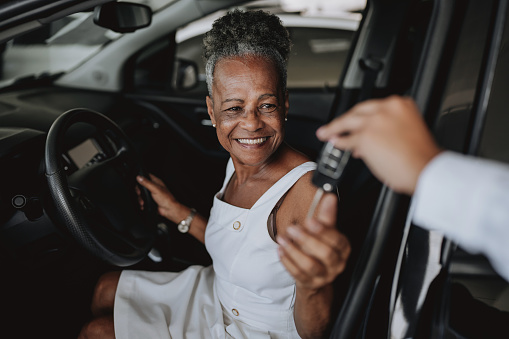 Senior woman buying car