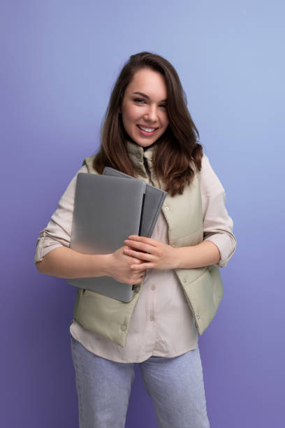 istock confident 30s woman boss business with a stack of documents and a laptop in her hands 1913376853