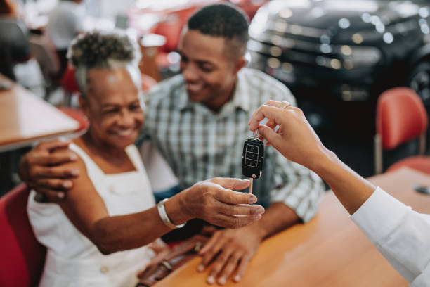 buying a car - car old african descent car salesperson stock-fotos und bilder