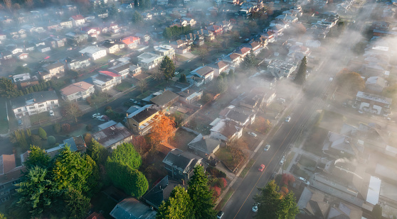 Neighborhood streets and homes covered in fog. Residential City suburb. Aerial View. BC, Canada.