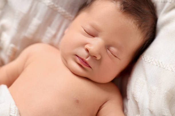 istock Cute newborn baby sleeping on white blanket, closeup 1913392837
