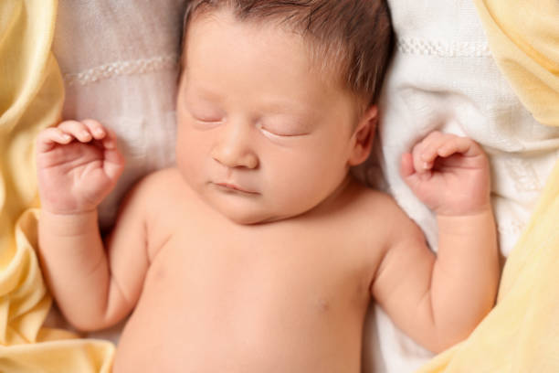 istock Cute newborn baby sleeping on white blanket, top view 1913393348