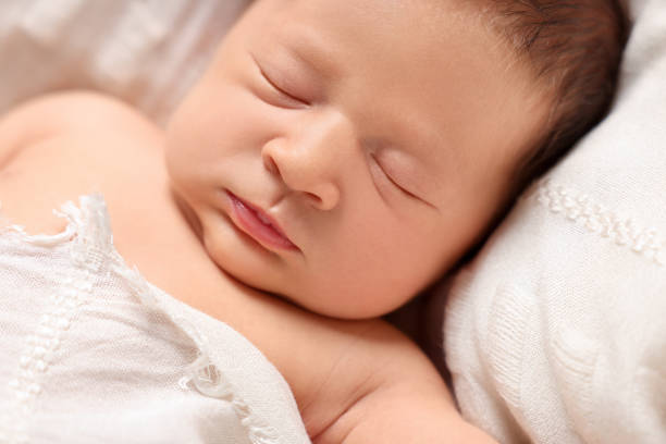 istock Cute newborn baby sleeping on white blanket, closeup 1913394405