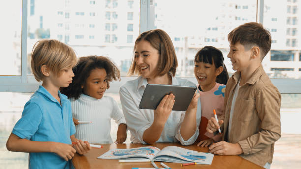 istock Teacher holding tablet while open online lesson to group of students. Erudition. 1913403587