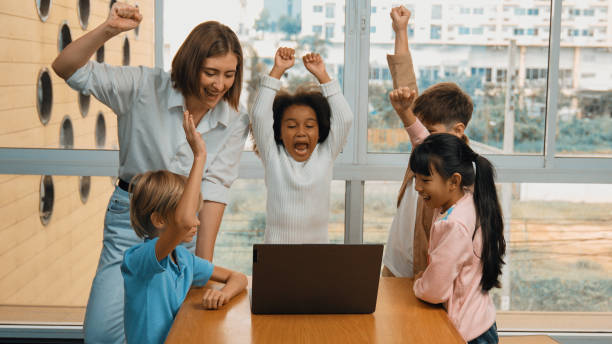 istock A group of diverse student and teacher celebrate successful project. Erudition. 1913415616