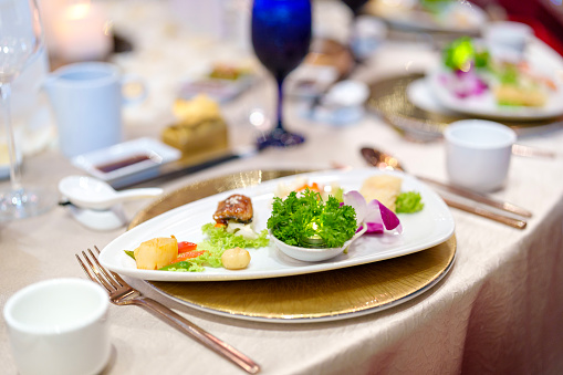 Table setting in a restaurant. Table setting with glasses, cutlery and plates. Restaurant interior.