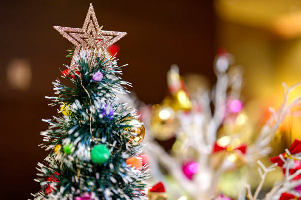 istock Beautiful Gold Christmas Star hanging on a Christmas Tree 1913593500