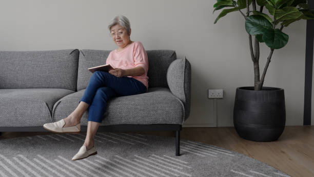 istock People - A senior Asian Chinese woman using her digital tablet device 1913616059