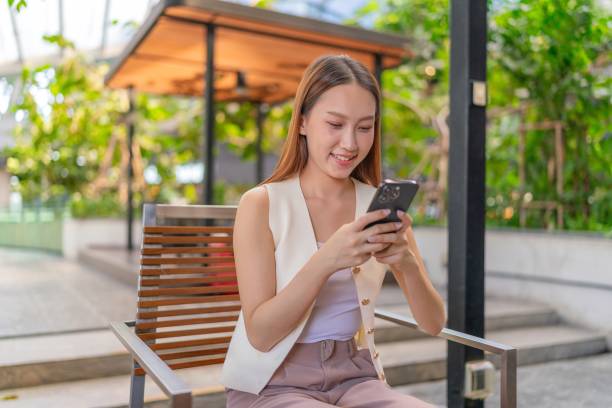 istock Empowered Connectivity. Asian Woman Utilizing Technology Outdoors with Phone 1913661448