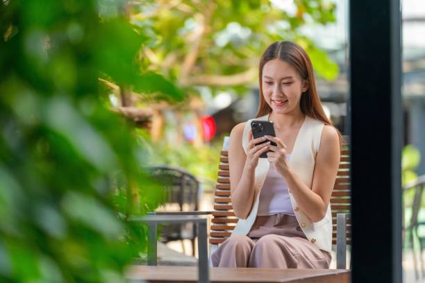 istock Empowered Connectivity. Asian Woman Utilizing Technology Outdoors with Phone 1913662951