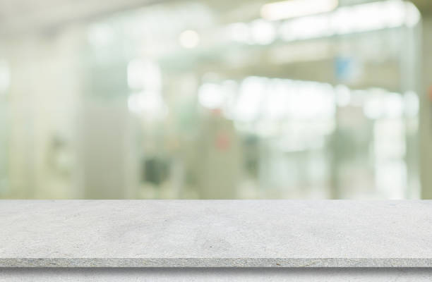istock Abstract blurred modern interior office room background with perspective cement quartz table for show, promote and design content or product on display concept 1913680476