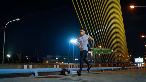 istock Asian man exercising in the city at night. 1913683569