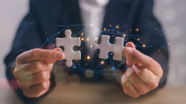 istock Business solutions, success, and strategy concept. Businessman hand connecting jigsaw puzzle. 1913802964