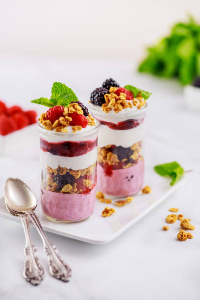 Greek yogurt, fruit and granola on top of pannacotta.