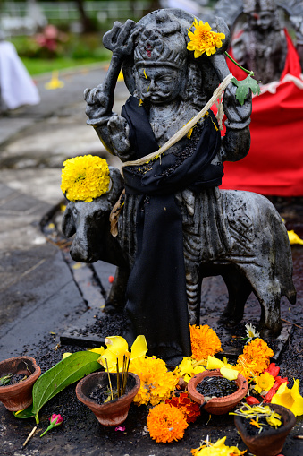 Grand Bassin, Mauritius - October 22 2023: Shani Dev Hindu God Statue in Grand Bassin or Ganga Talao, Mauritius with Flower Offering or Sacrifice