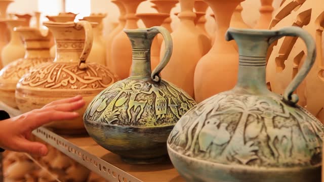 Ceramics shop in Manama Bahrain man choosing a ceramic vase in the pottery shop