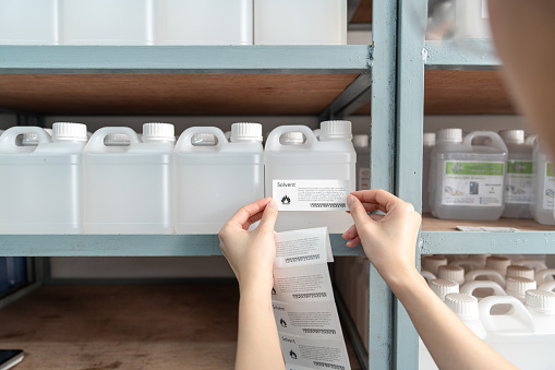 Solvent Storage Sticker Chemist Puts A Barcode Sticker On A Plastic Bottle Containing A Solvent ...