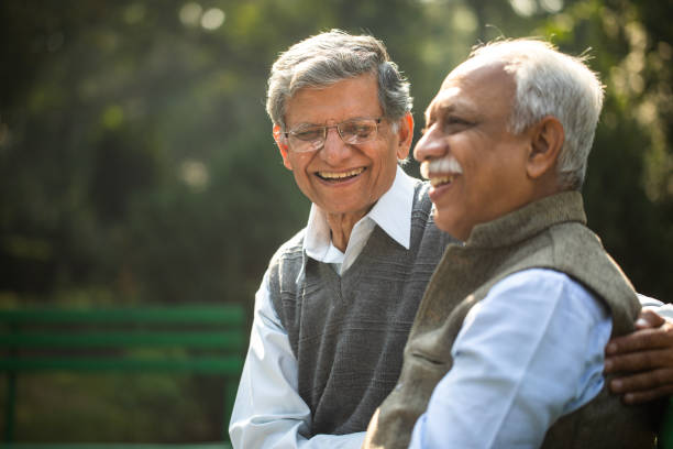 istock Happy elderly friends resting on park bench 1913860114