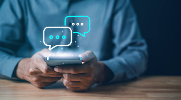 istock Technology, communication, Social media text messaging concepts, Businessman using smartphone texting message while sitting on table with in work office. 1913909322