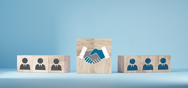 hand shaking icon on wooden cube blocks and human in circle icon for business deal concept. Teamwork process of partner, best relationship. For business contract,