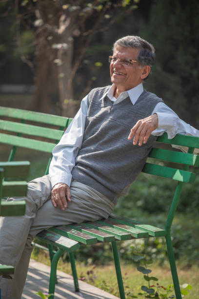 istock Thoughtful elderly man sitting on park bench 1913980565