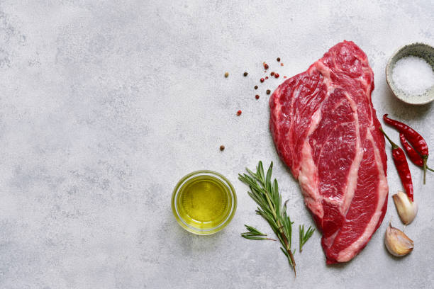 istock Raw organic marbled beef steak with ingredients for cooking. Top view with copy space. 1913985153