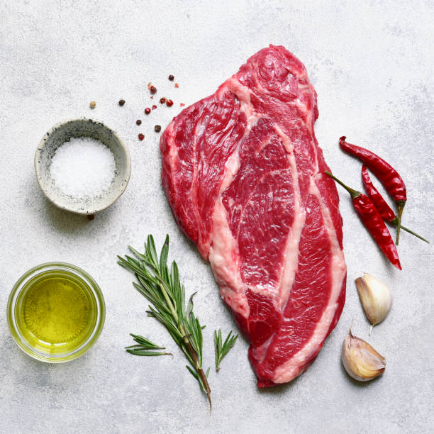istock Raw organic marbled beef steak with ingredients for cooking. Top view with copy space. 1913985211