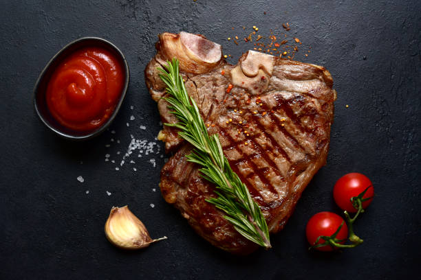 istock Grilled T-bone beef steak. Top view with copy space. 1914059941
