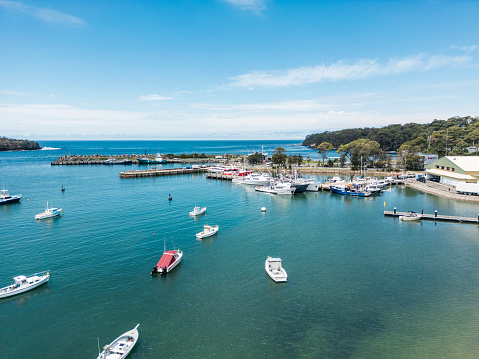 Vlichada beach bay, Santorini, Greece - August 2022 : Panoramic view of the port with yachts and boats moored to shore