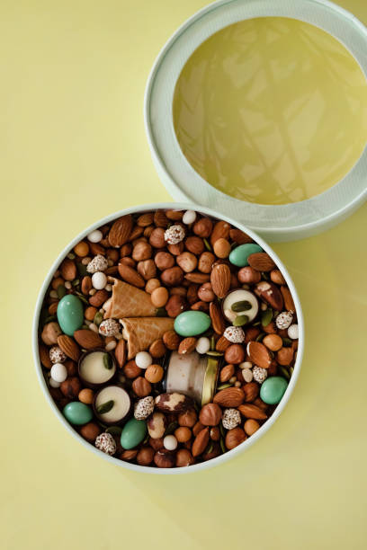 istock On a light background there is a round box filled with various nuts and dried fruits. Mothers Day. Valentine's Day. International Women's Day.A delightful gift. Low-fat food. 1914111136