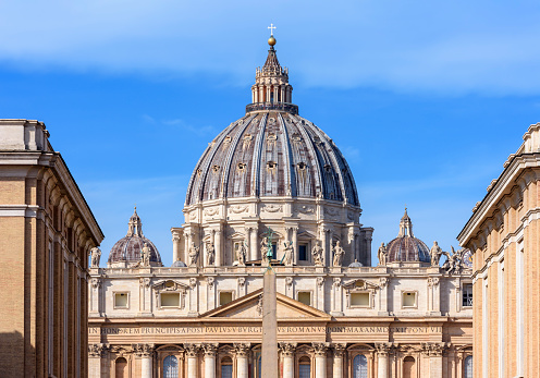 Vatican - October 2022: St. Peter's basilica dome and Egyptian obelisk on St. Peter's square in Vatican