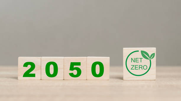 istock net zero emissions and Carbon neutrality concept. sustainable and clean tech. global warming. Environmental protection, climate eco energy. Net zero wood icon on table. Renewable pure power. 2025. 1914121080