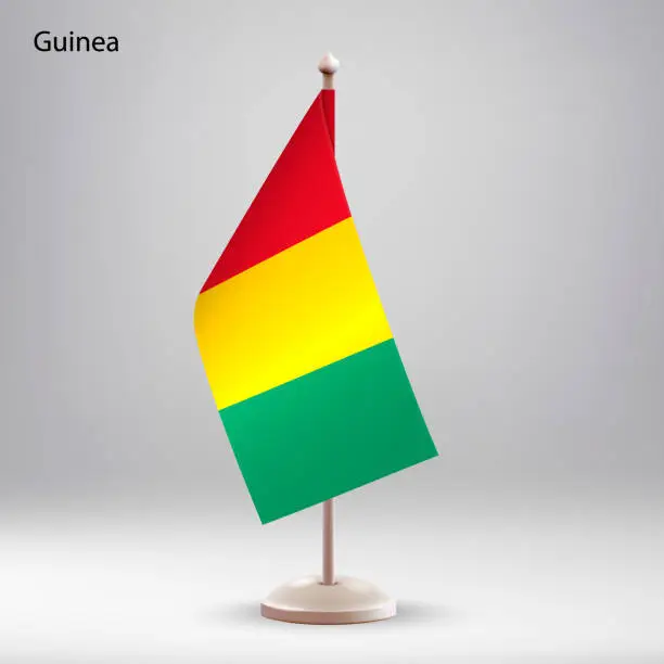 Vector illustration of Flag of Guinea hanging on a flag stand.